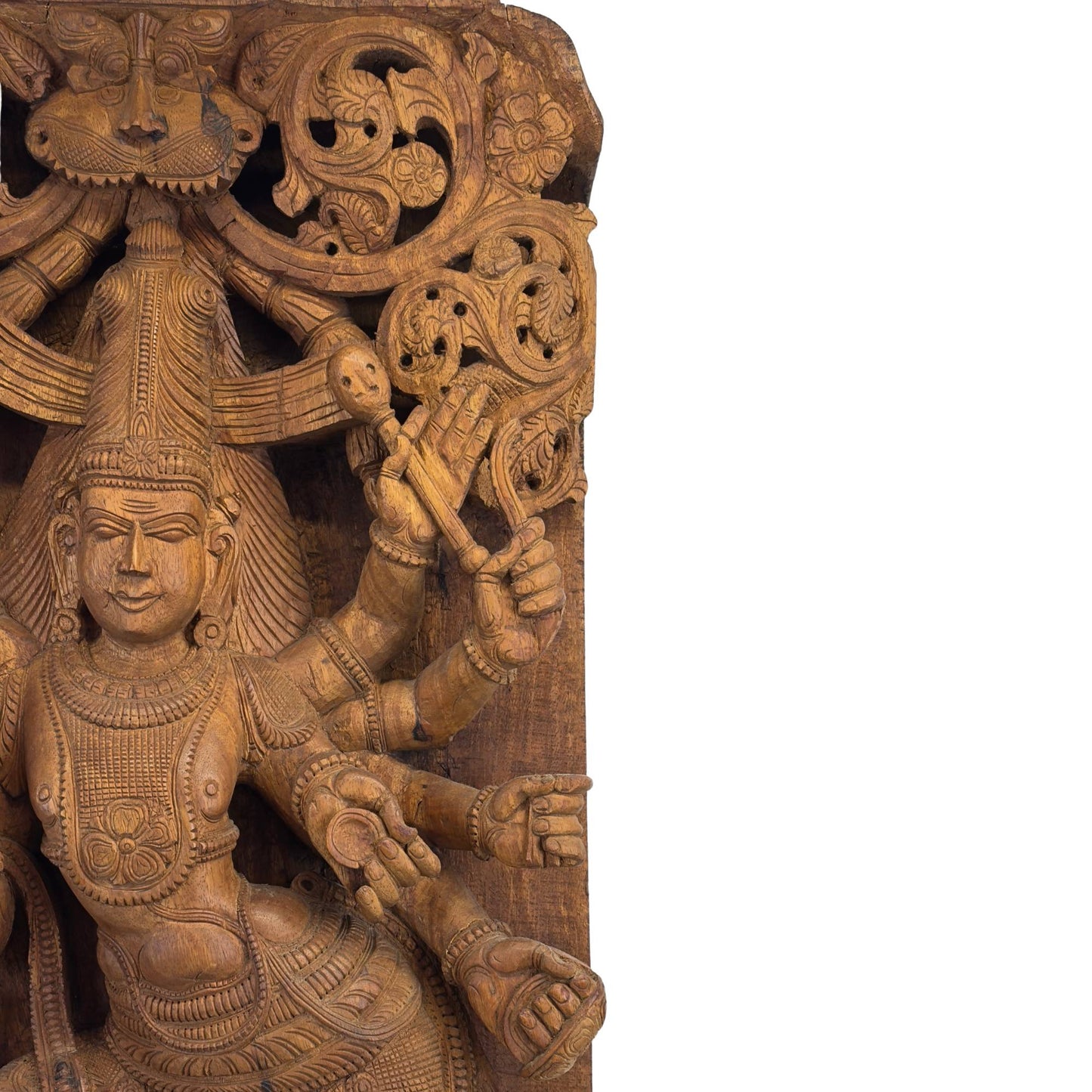 Detail van de bovenzijde van het architectonische paneel met het beschermende Kirtimukha masker en opengewerkt floraal snijwerk.